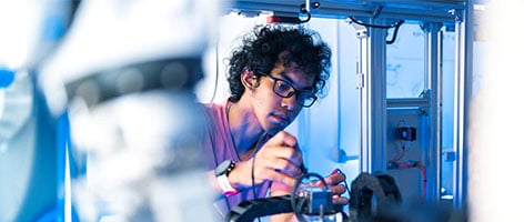 Young man using artificial intelligence technology in a lab