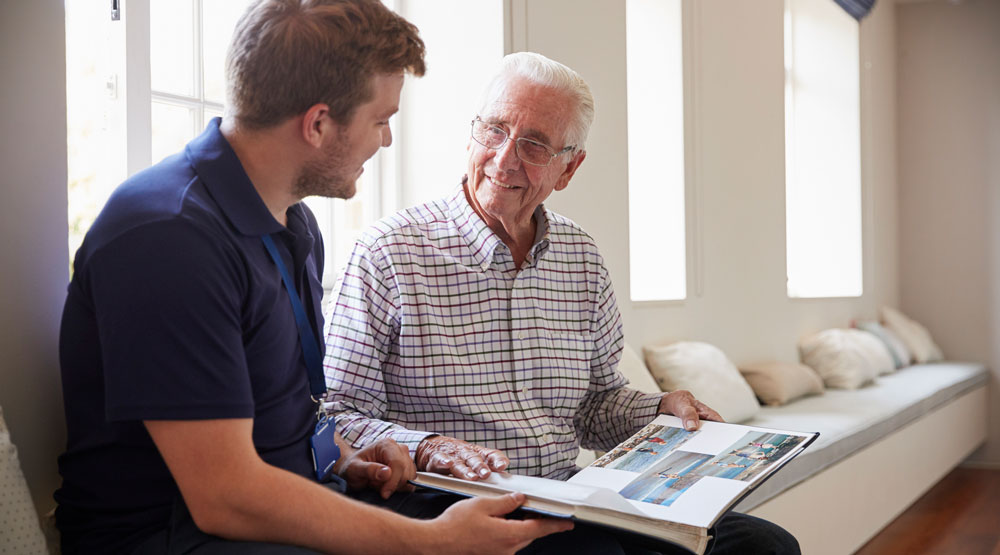 Care worker talking with dementia patient