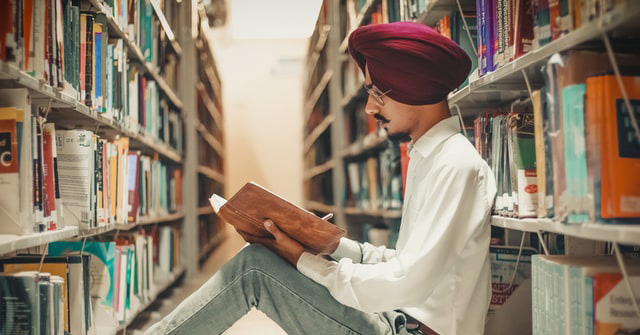 Creative writing student reading in a library
