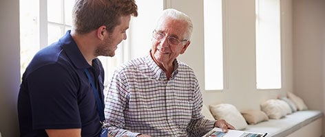 Elderly man with carer