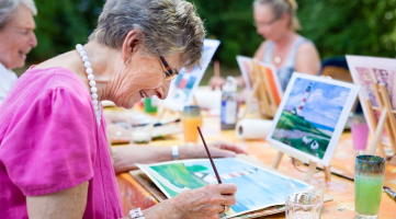 Dementia patient painting with group