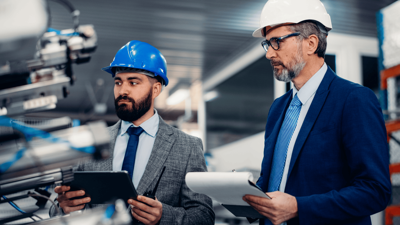 Two engineering managers examining some machinery