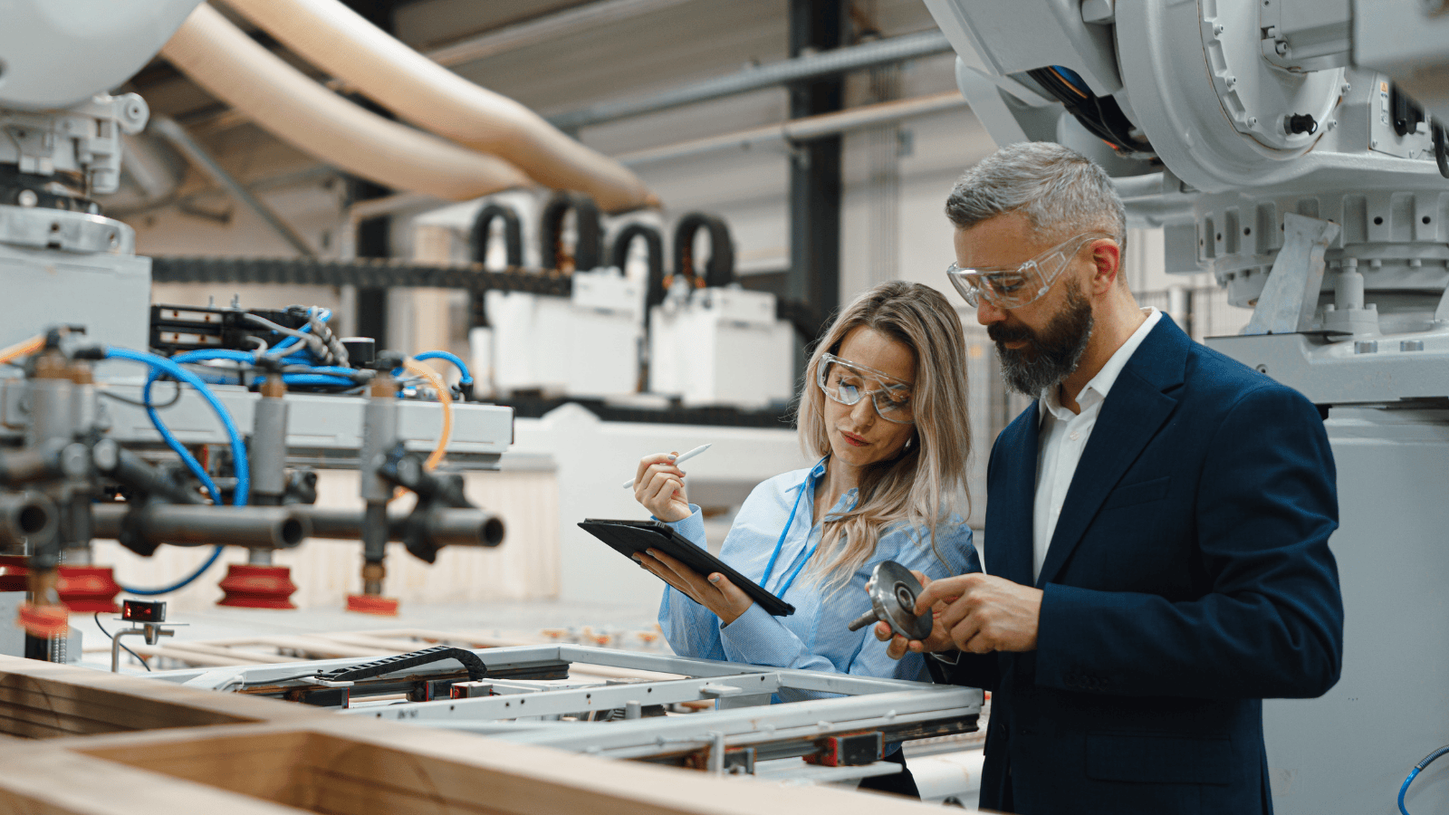 Two engineering managers having a discussion around machinery