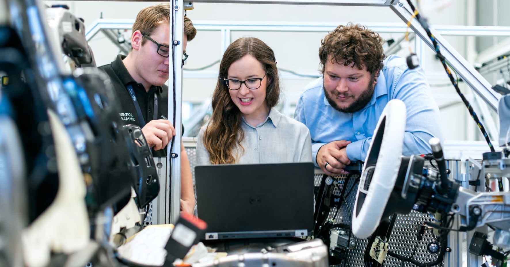 Engineering managers working with tech in a lab