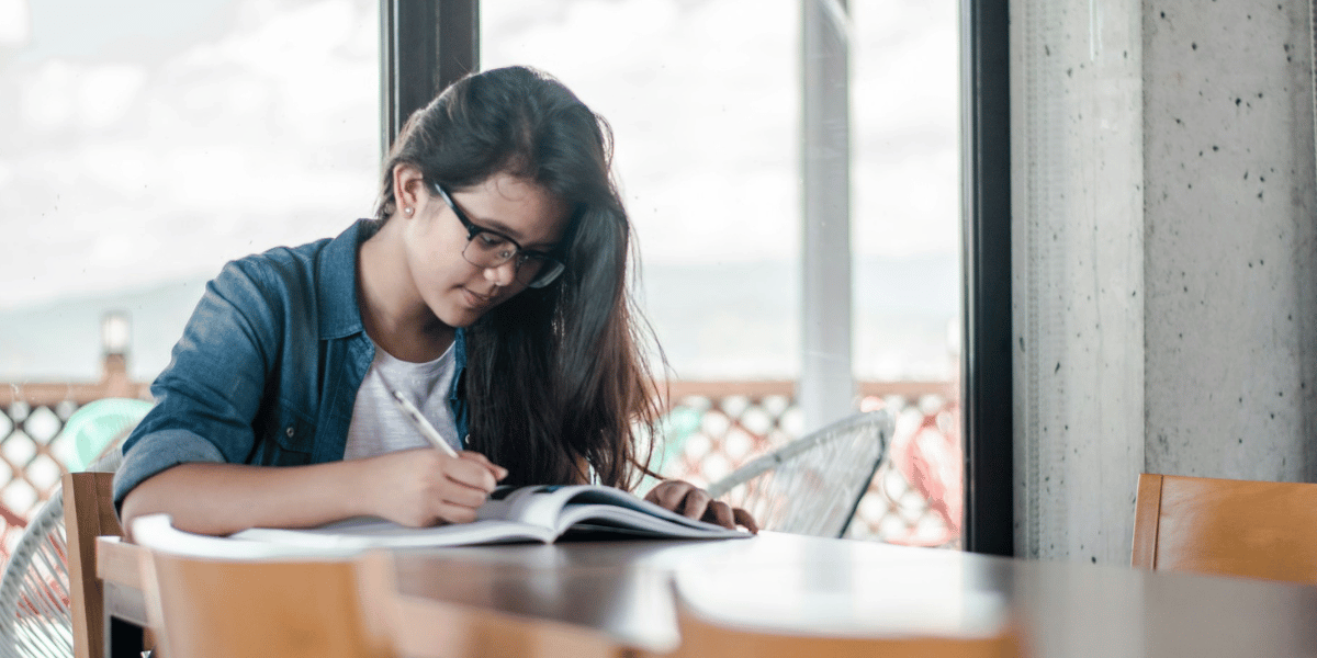 Female student writing in a notebook