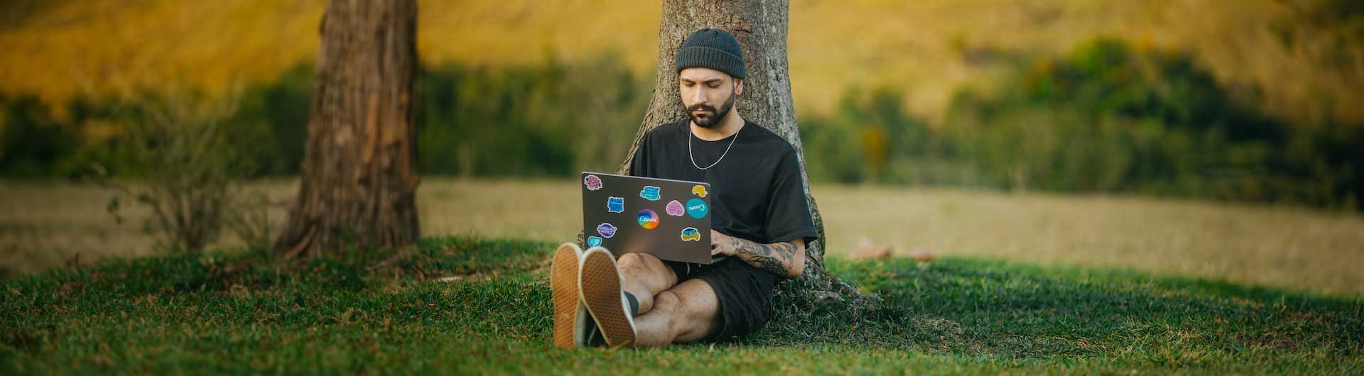 Hull Online student working on a laptop outside