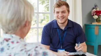 Dementia care professional speaking with a patient