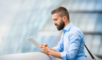 Man watching webinar on a tablet