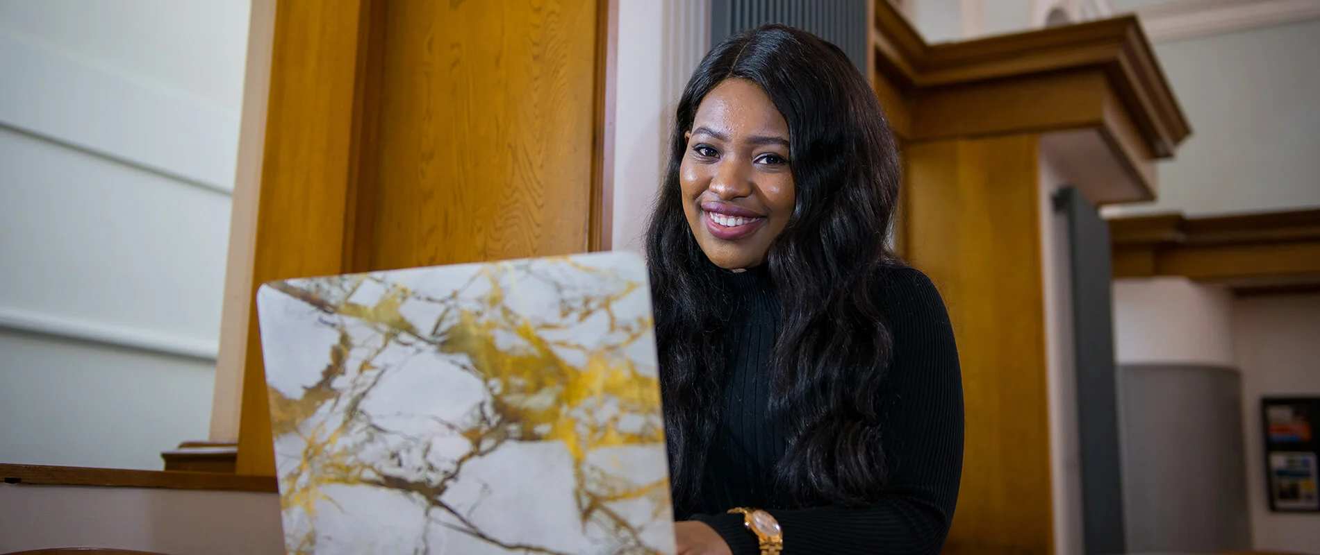 Smiling Hull Online student with a laptop