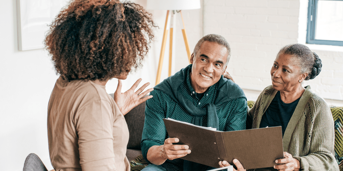 A couple speaking with a dementia care provider