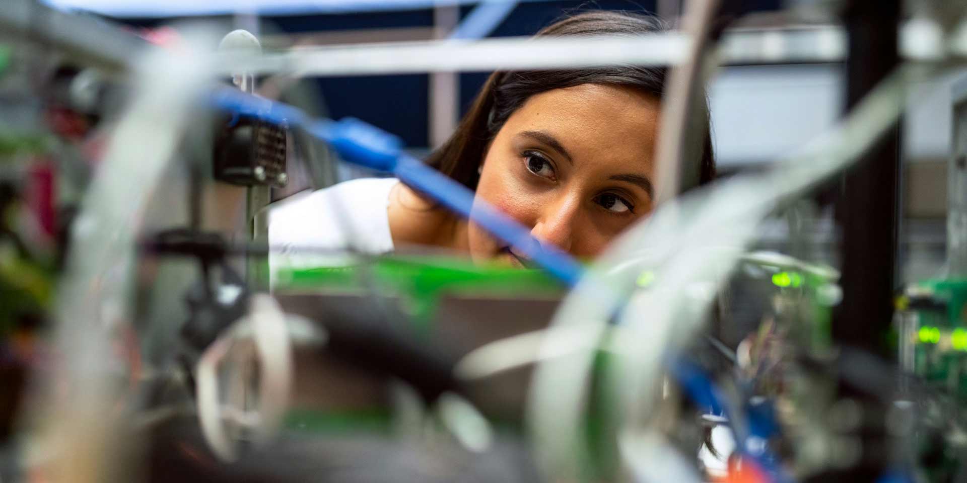 Engineering professional looking at wires